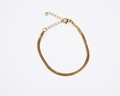 Gold bracelet on a white background