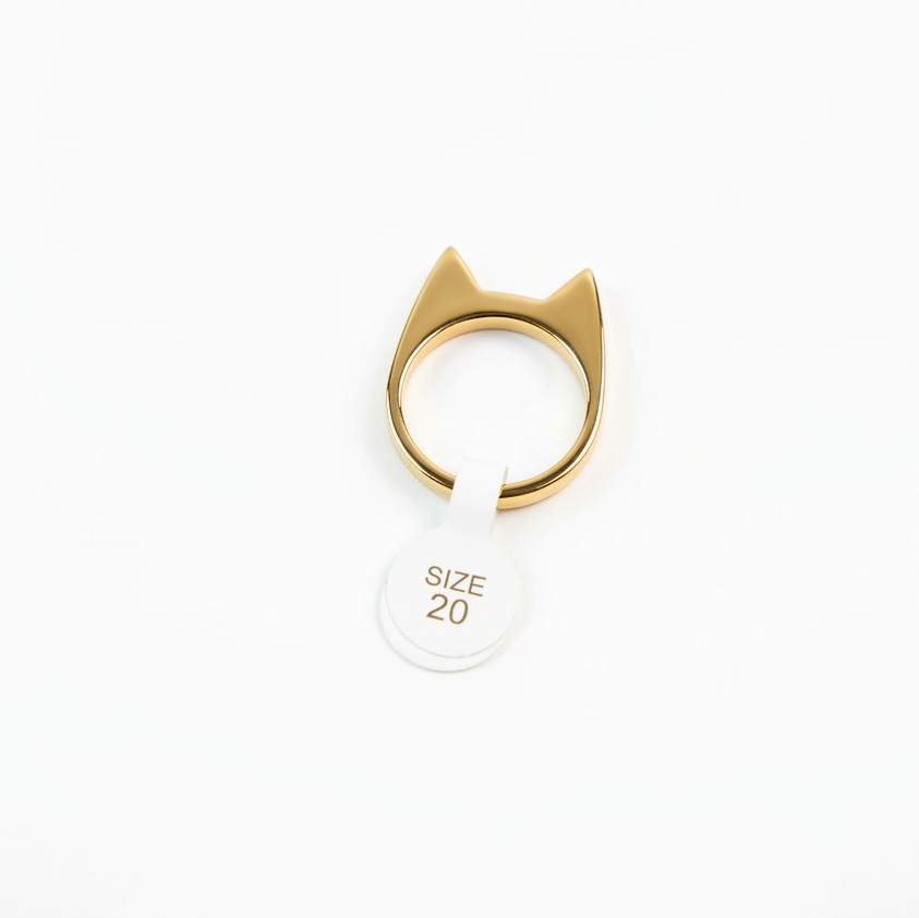 Gold cat-shaped ring on a white background