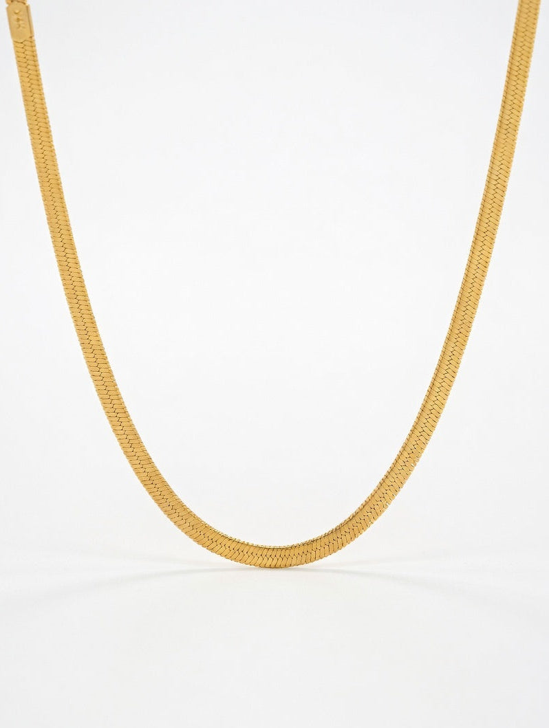 Gold chain necklace on a white background with 'Luxe Jewels' branding.