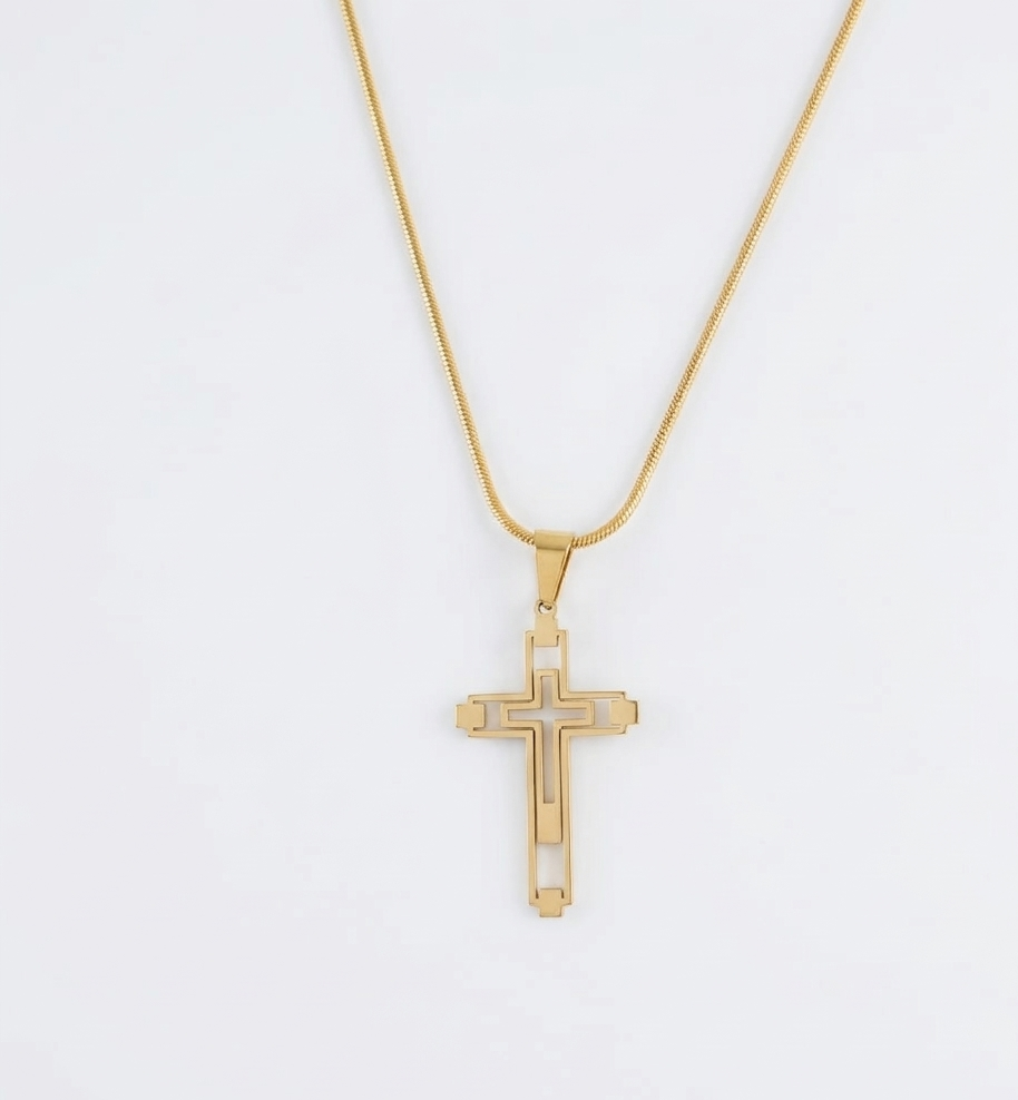 Gold cross necklace on a white background