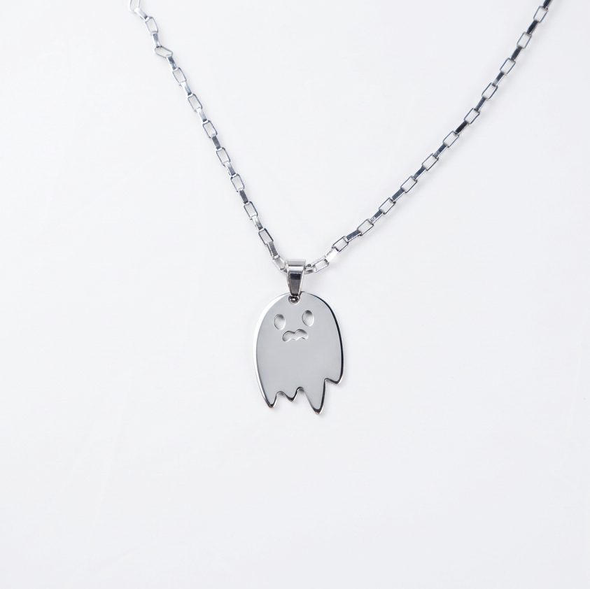 Silver ghost-shaped pendant on a chain against a white background